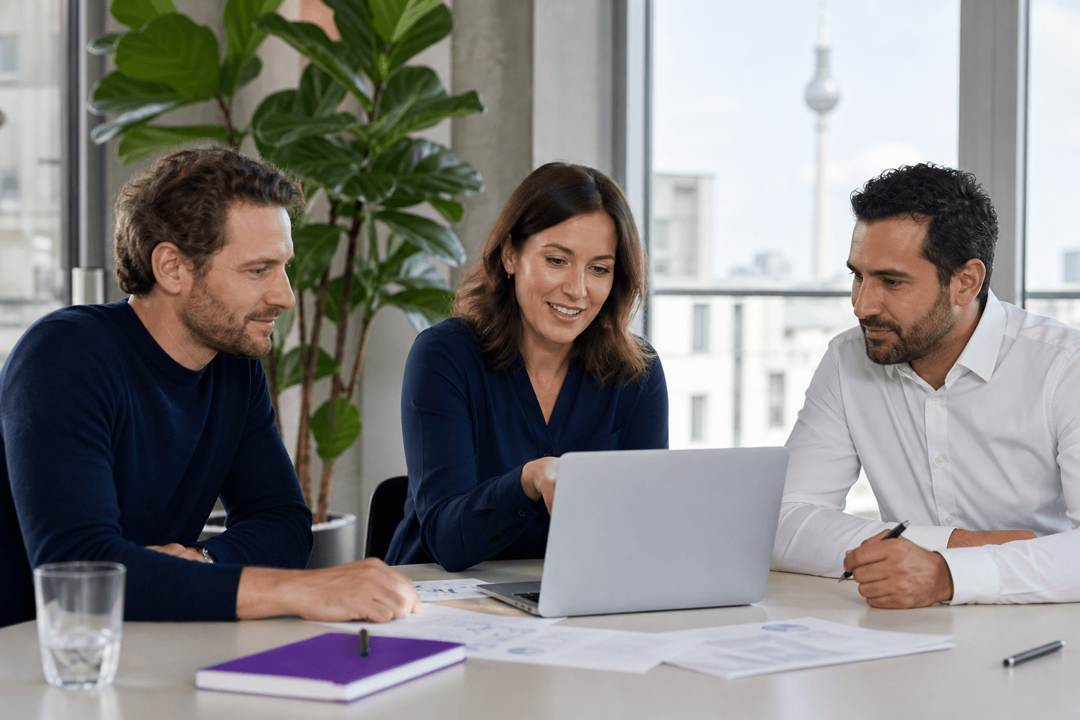 Colleagues reviewing funding documents on a laptop
